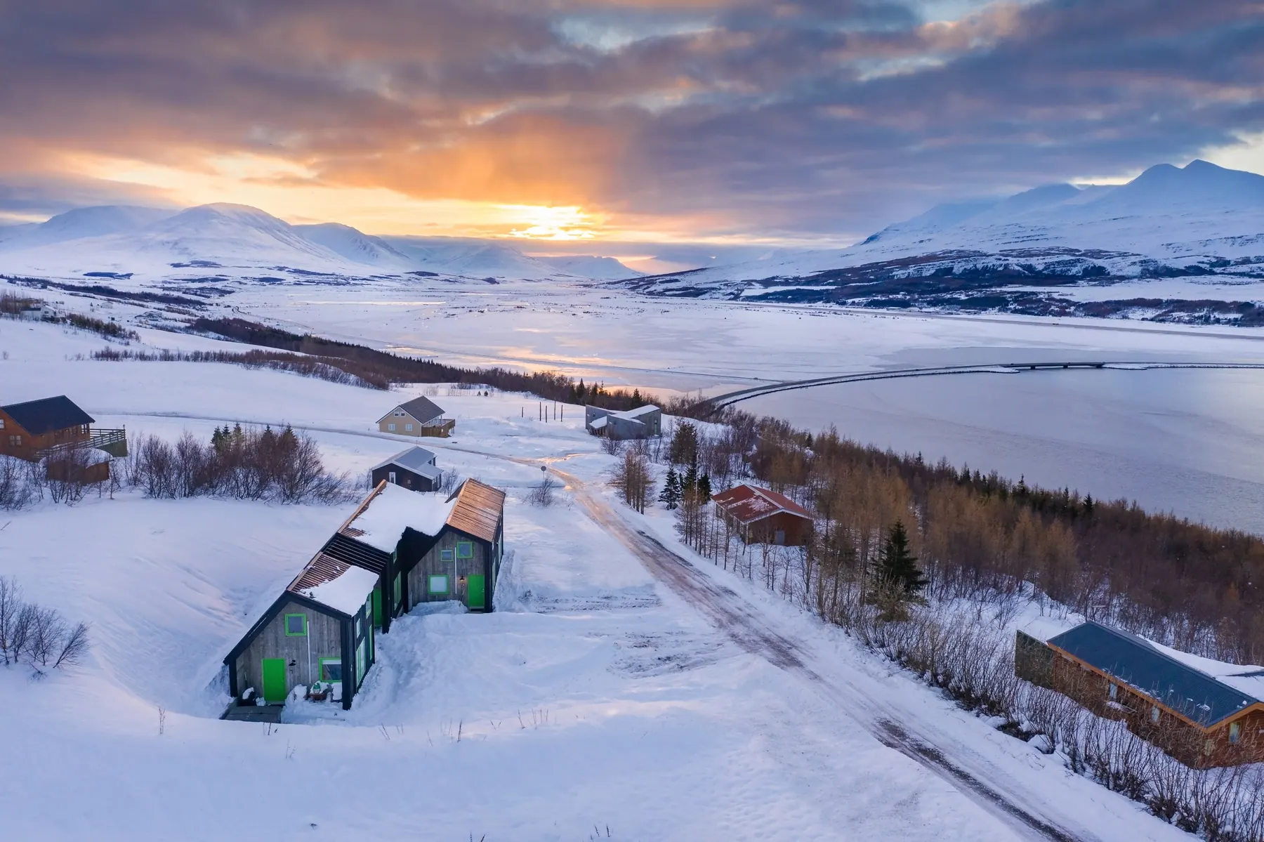 Apartment 15A: The houses in winter snow at sunset, above the fjord