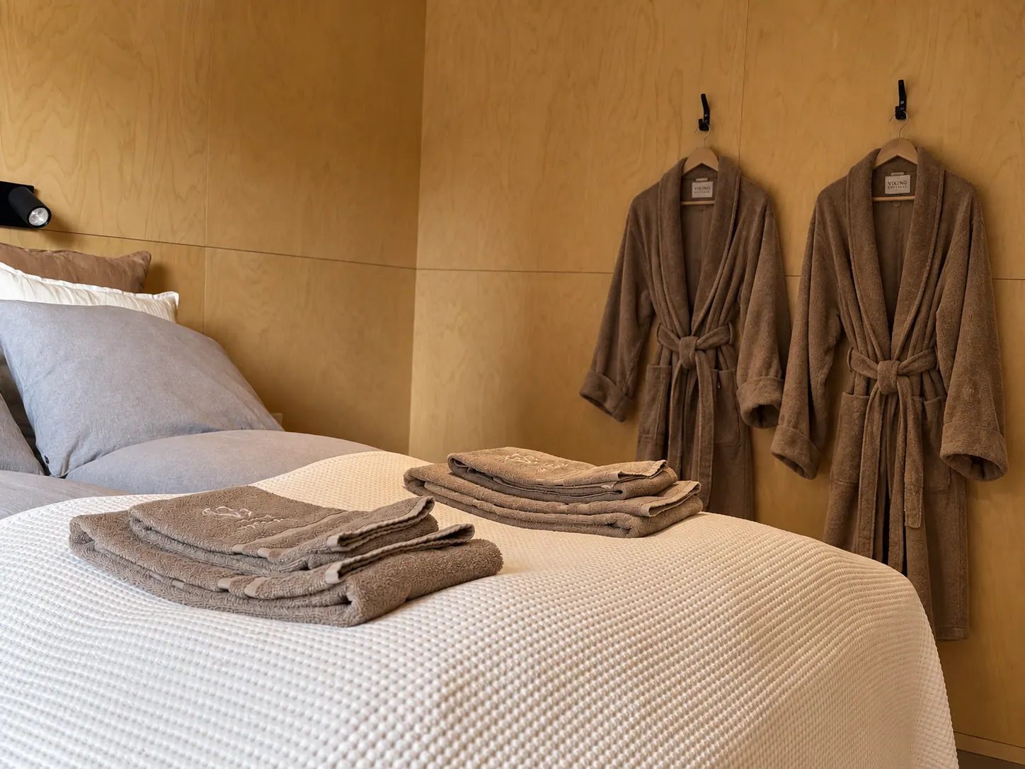 Apartment 15B: Bed with towels and two bathrobes