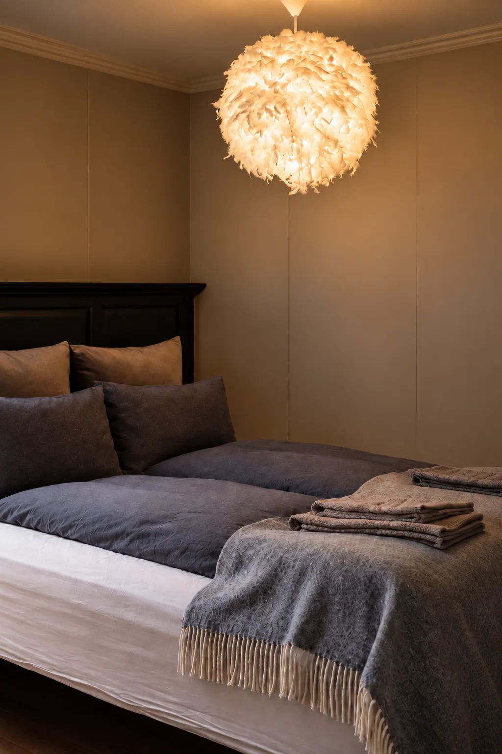 The Cottage: Bed with grey linen under a paper lamp