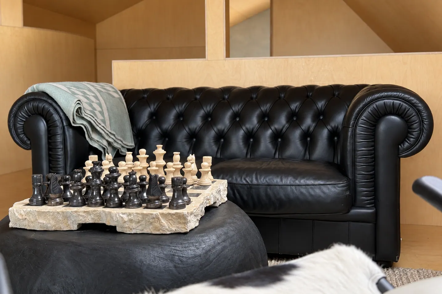 Apartment 15B: Leather sofa with a chess set