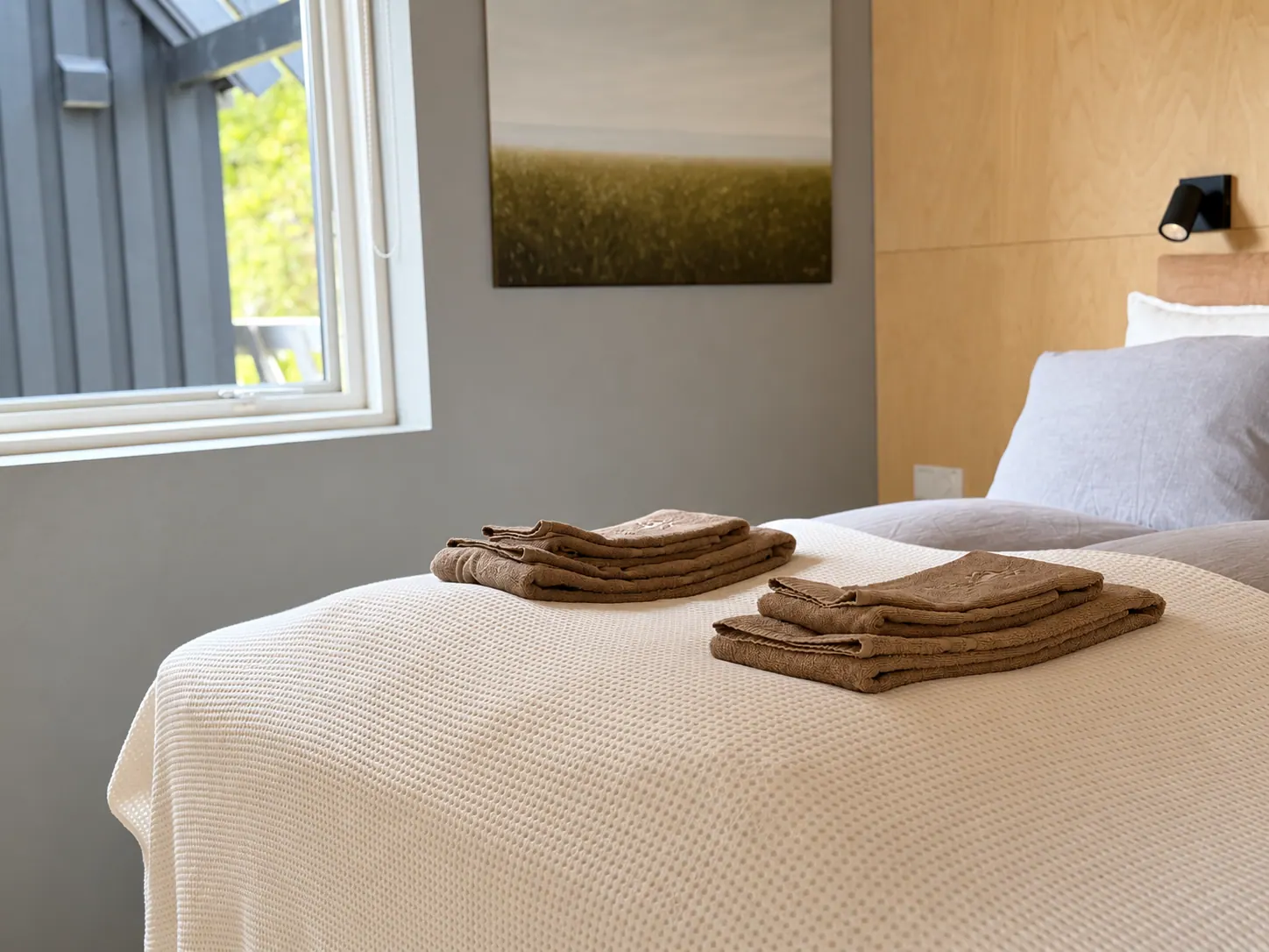 Apartment 15B: Bedroom with a made-up bed and towels